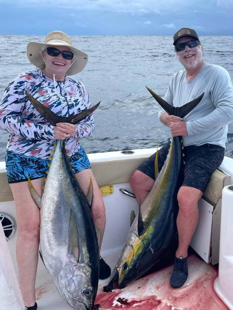 Happy couple holding a prized Yellowfin Tuna during a 2026 Southern Costa Rica fishing charter
